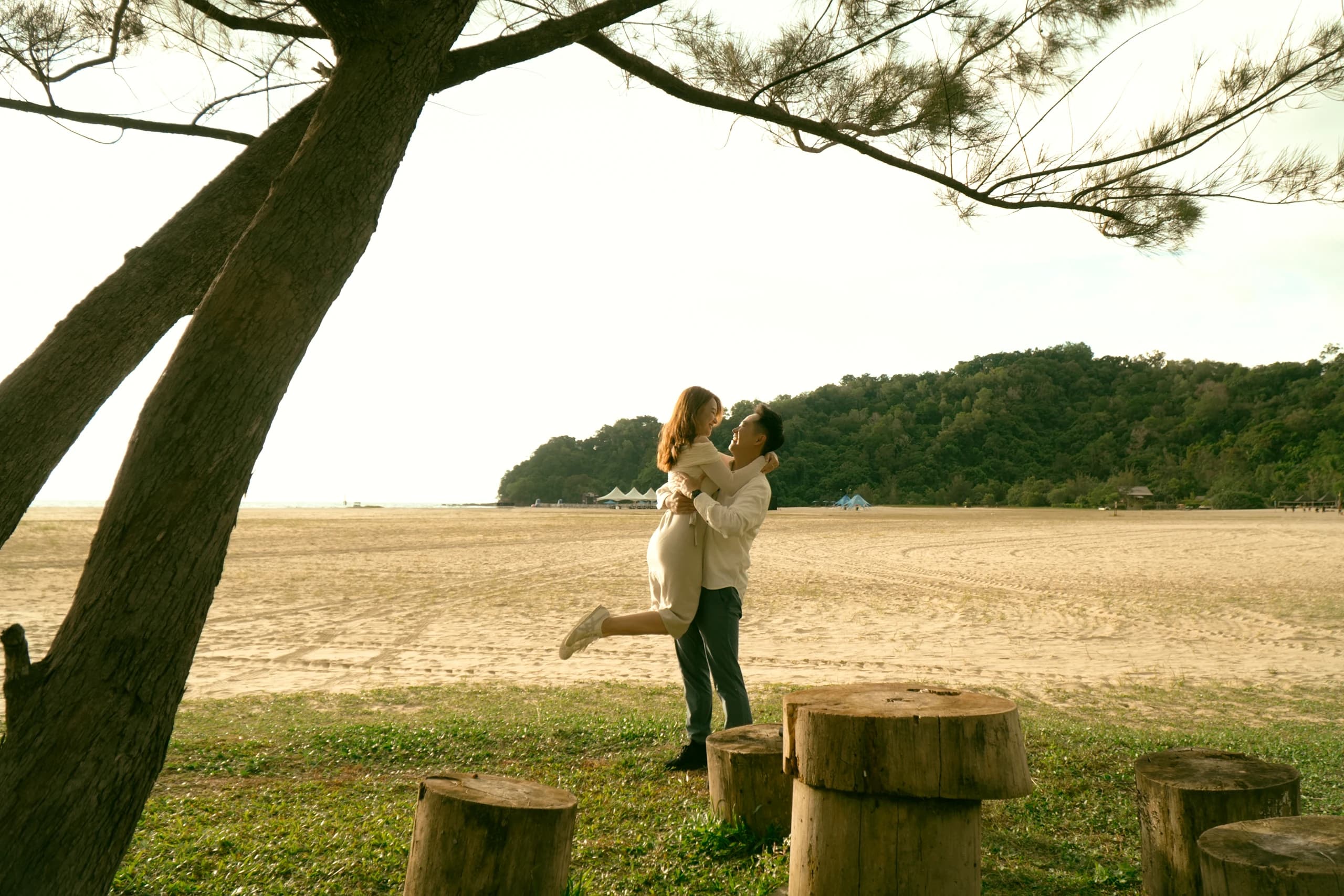 Ian lifting Phy beneath the trees at Rasa Ria
