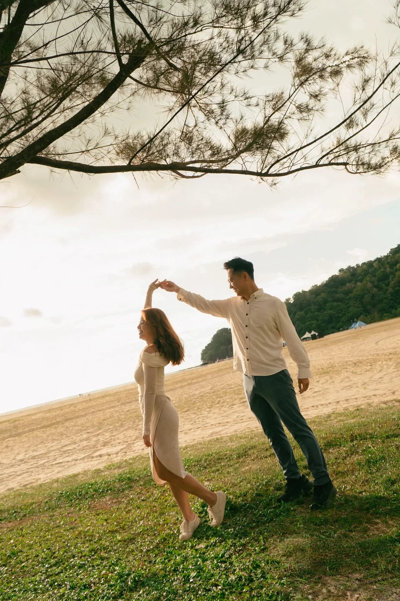 Ian twirling Phy beside the beach at Rasa Ria